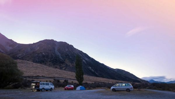 Campervans parked at Lake Pearson / Moana Rua Wildlife Refuge located in Craigieburn Forest Park in Canterbury region South Island of New Zealand